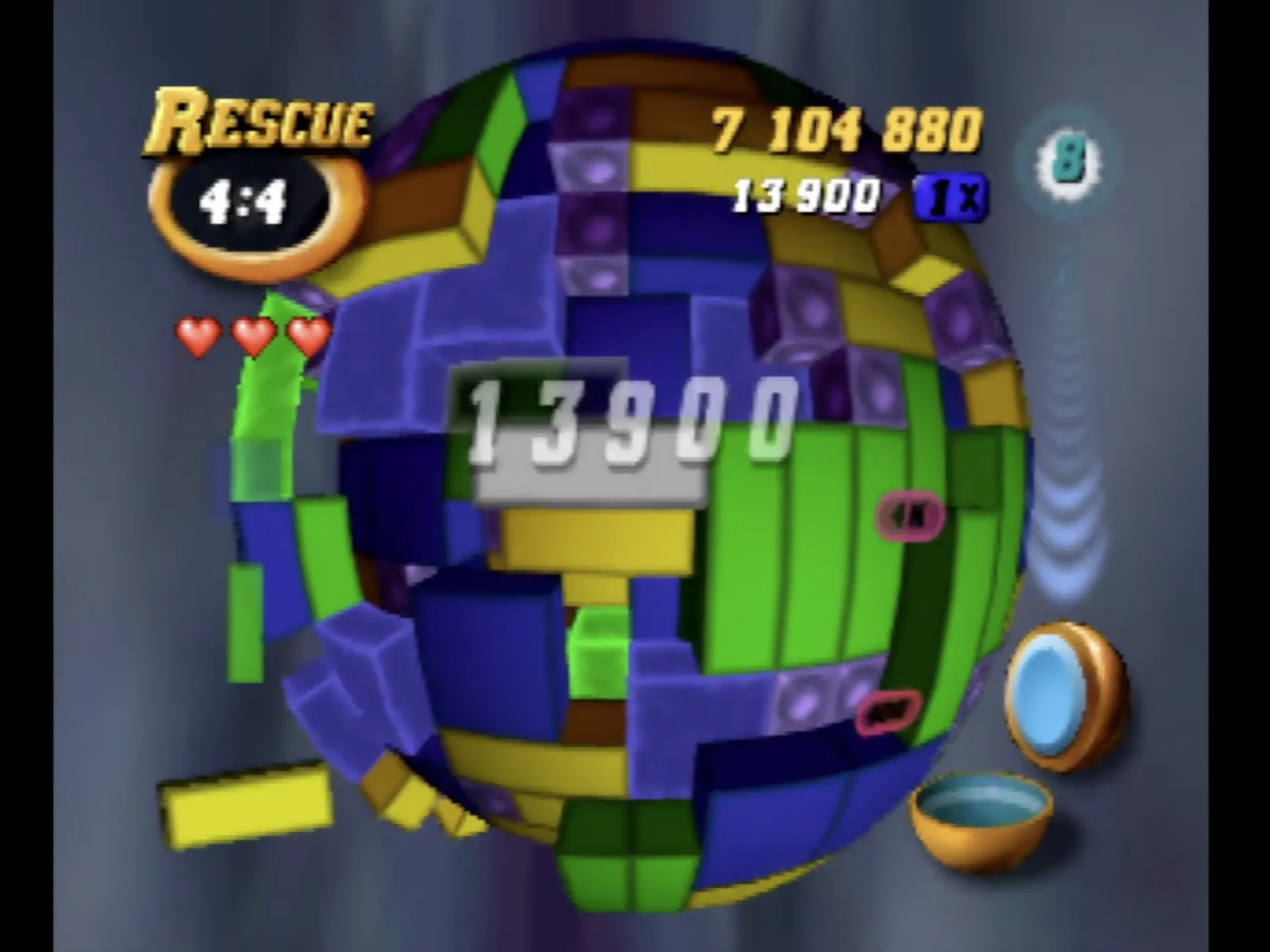 Hình ảnh game xếp hình 3D Tetrisphere trên Nintendo 64, thể hiện các khối màu sắc vây quanh một quả cầu trung tâm.