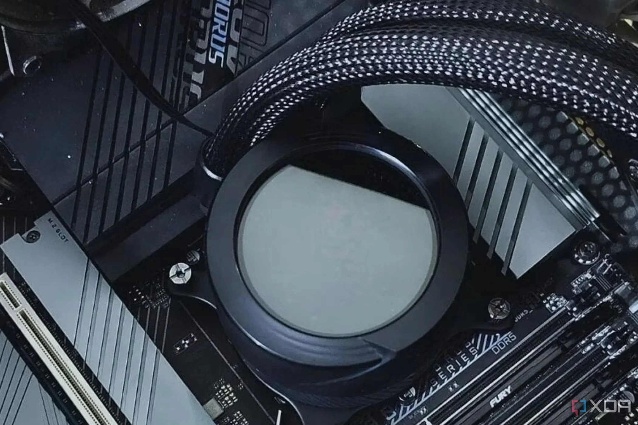Khối tản nhiệt nước (liquid cooler waterblock) được gắn trên bo mạch chủ, đại diện cho các yếu tố phần cứng ảnh hưởng đến hiệu năng CPU