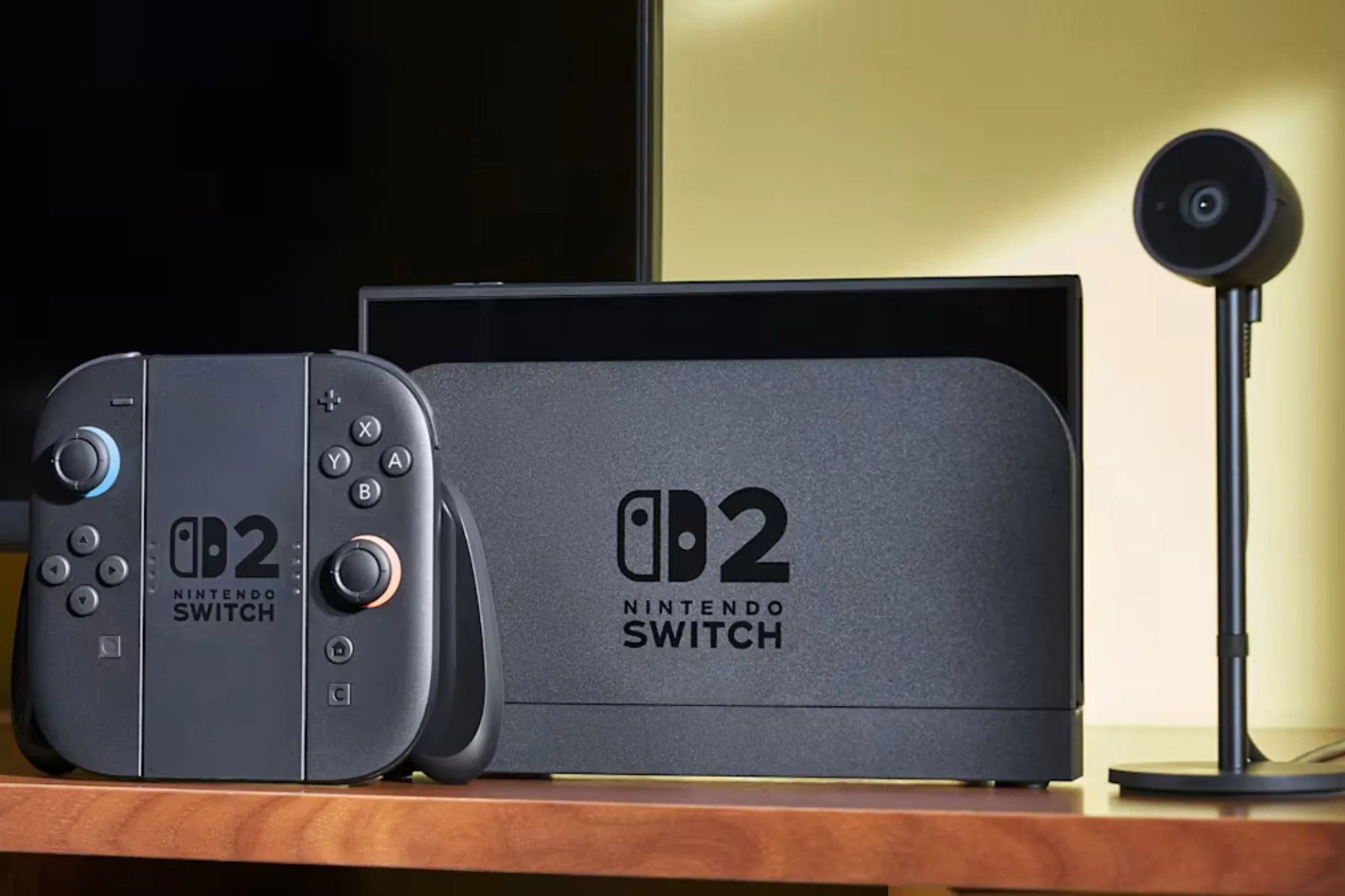 Máy chơi game Nintendo Switch 2 và phụ kiện camera đặt trên bàn, tượng trưng cho sự tiện lợi và đa năng của hệ máy.